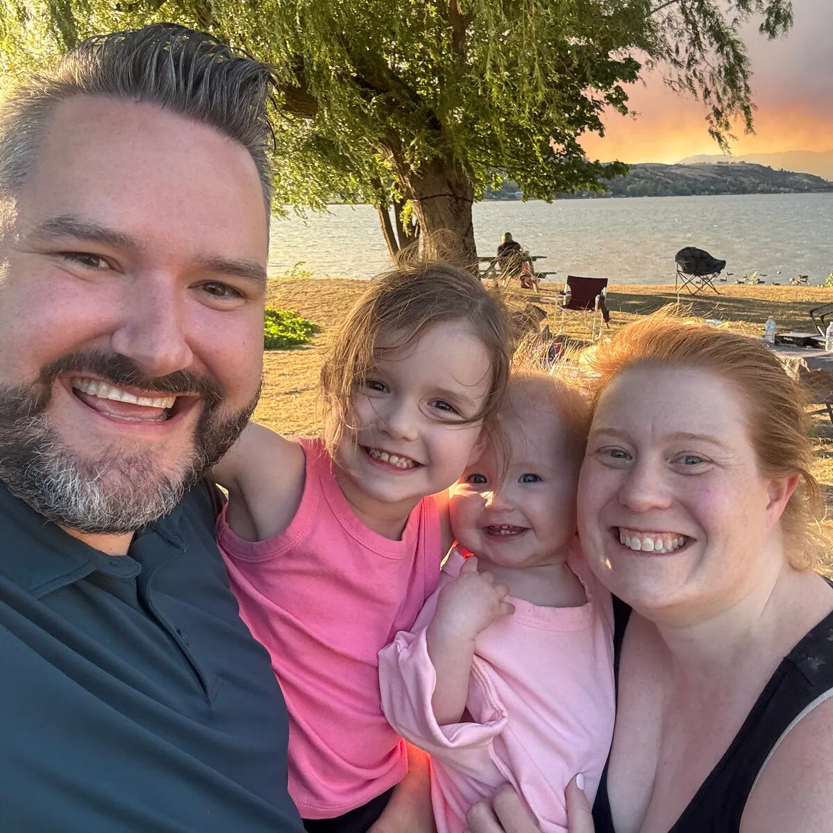 Jessica with her daughters at the beach at sunset